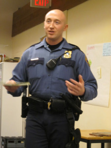 Officer Ryan Bren addresses KNA